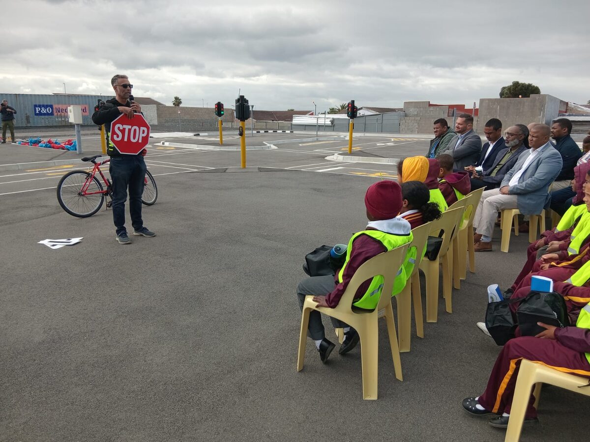 Pedal Power Africa's Zane van Aarde teaches the children about cycling safety.