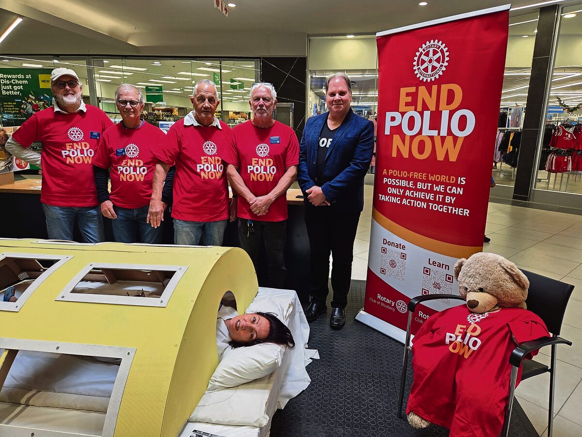 Pres Jackie Claydon lying in the "iron lung" while Blouberg members support the awareness campaign. Pictured at the back from left are Dirk-Jan Dijkstra, Olivier Baudry, Peter Rokitta, Graham Claydon and Jacques Pratt.