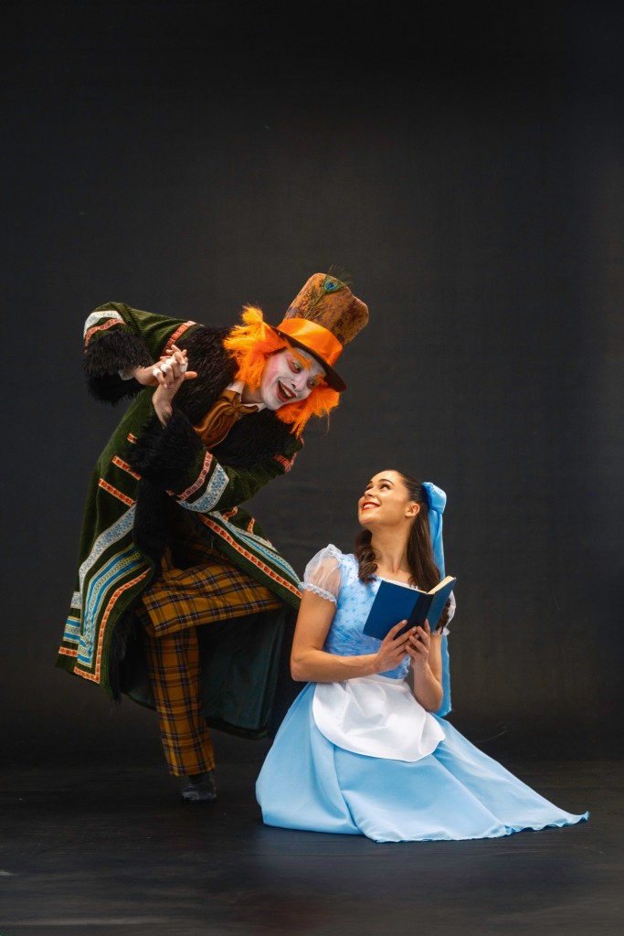 Photo of Leusson Muniz as the Mad Hatter and Isabella Blair as Alice.
