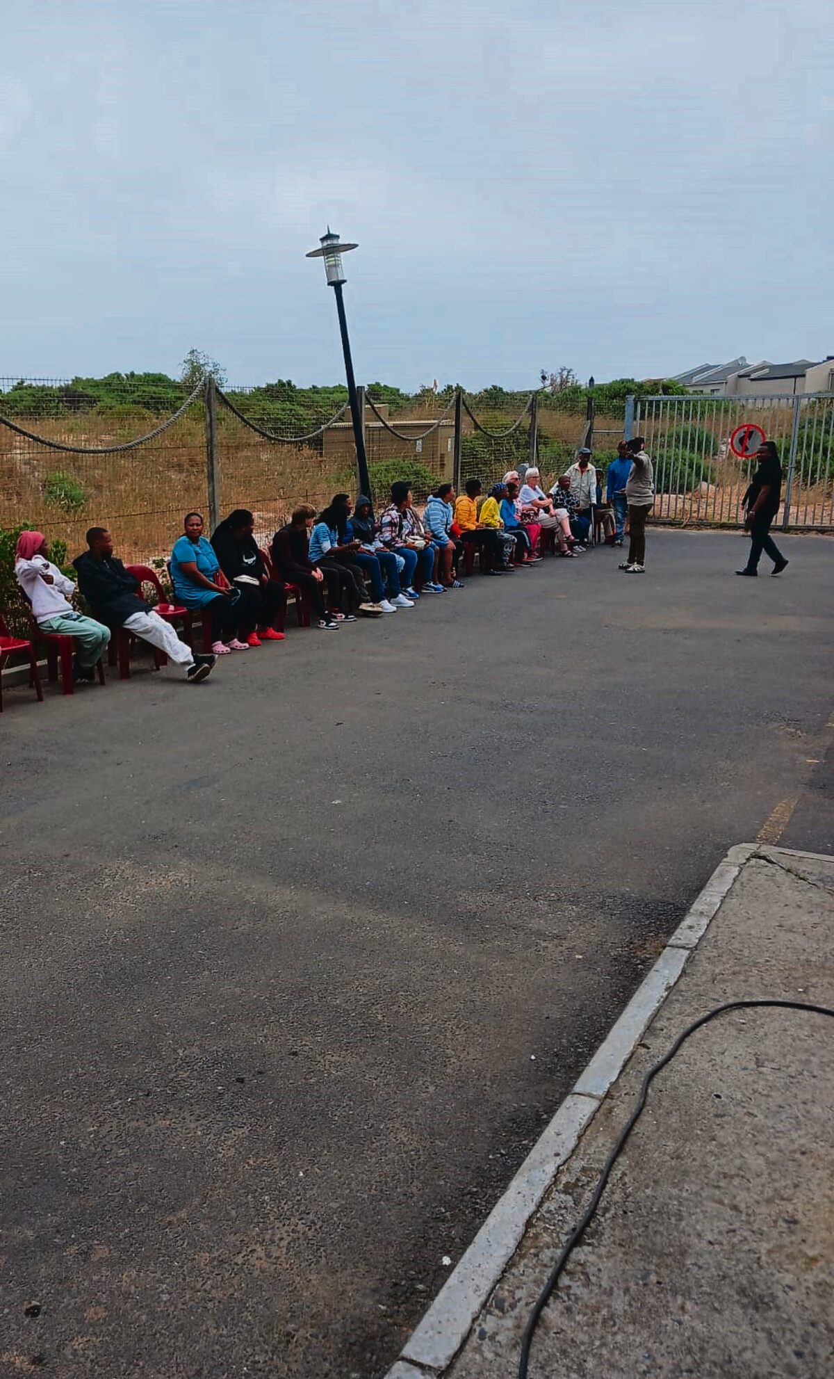 Residents queue outside the mobile Home Affairs units in Melkbosstrand to apply for new and replacement IDs.
