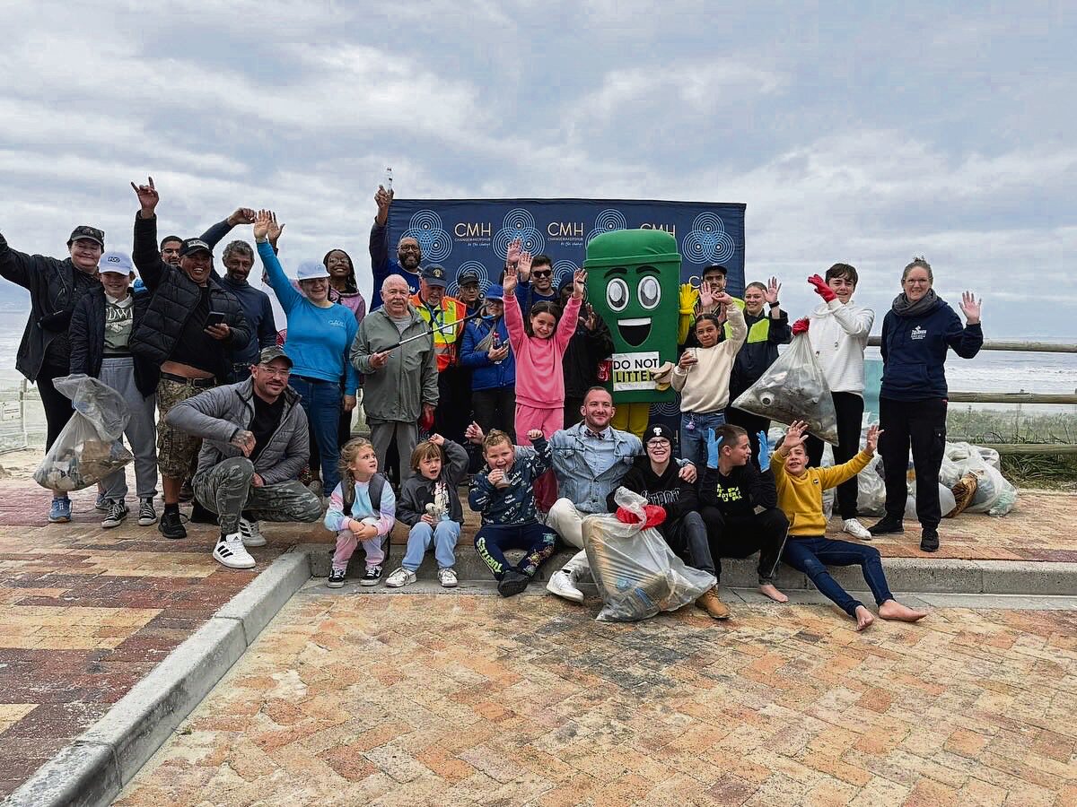 Volunteers pose with the City’s mascot after clearing several bags of litter during a previous cleanup.