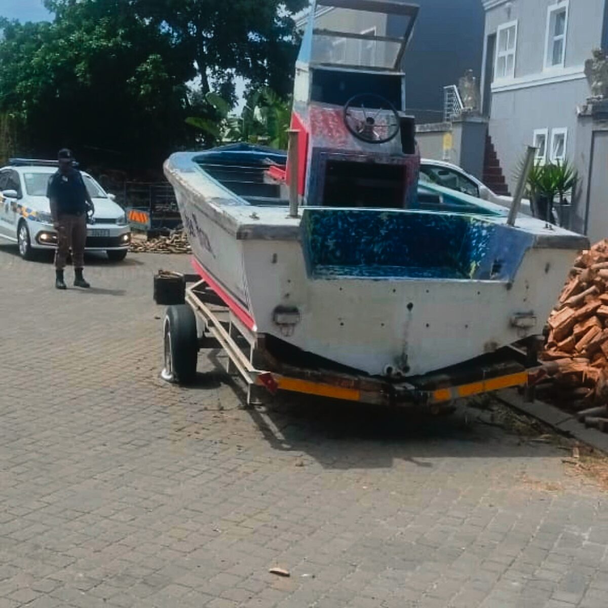 
An officer inspecting a long-standing abandoned boat.