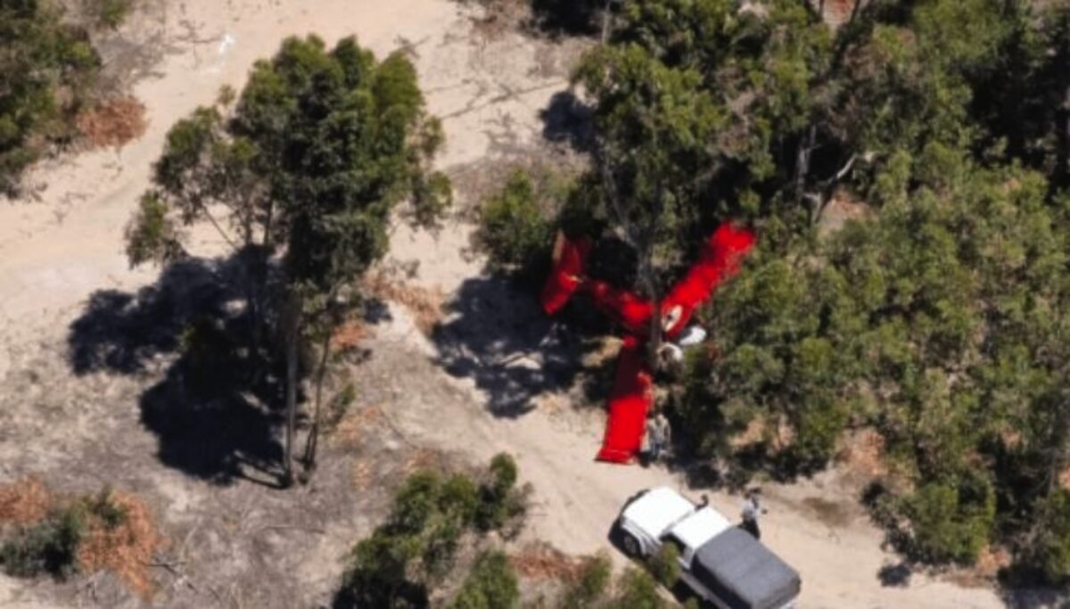 The crash site visible from a distance as police and paramedics take control of the scene.