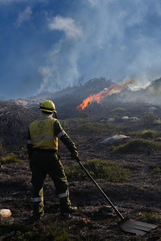 A firefighter surveys flare-ups during a long night on the fireline. Photo: NCC Environmental Services