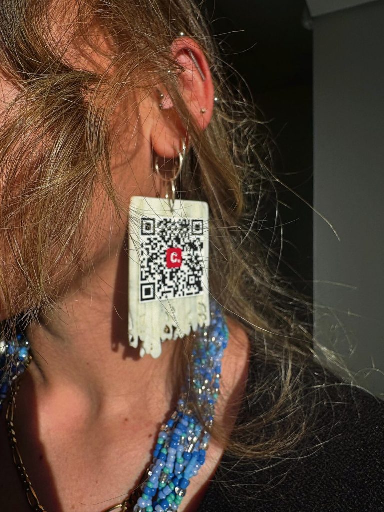 Zoë's earrings feature a QR code linking straight to her petition.