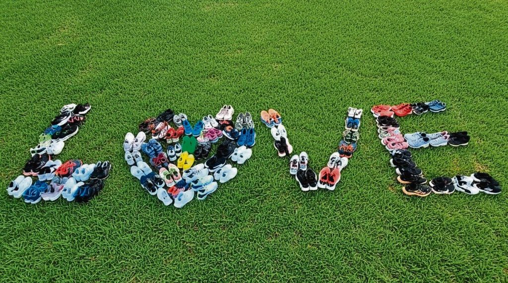 he donated sports shoes were packed out to display the word "love".