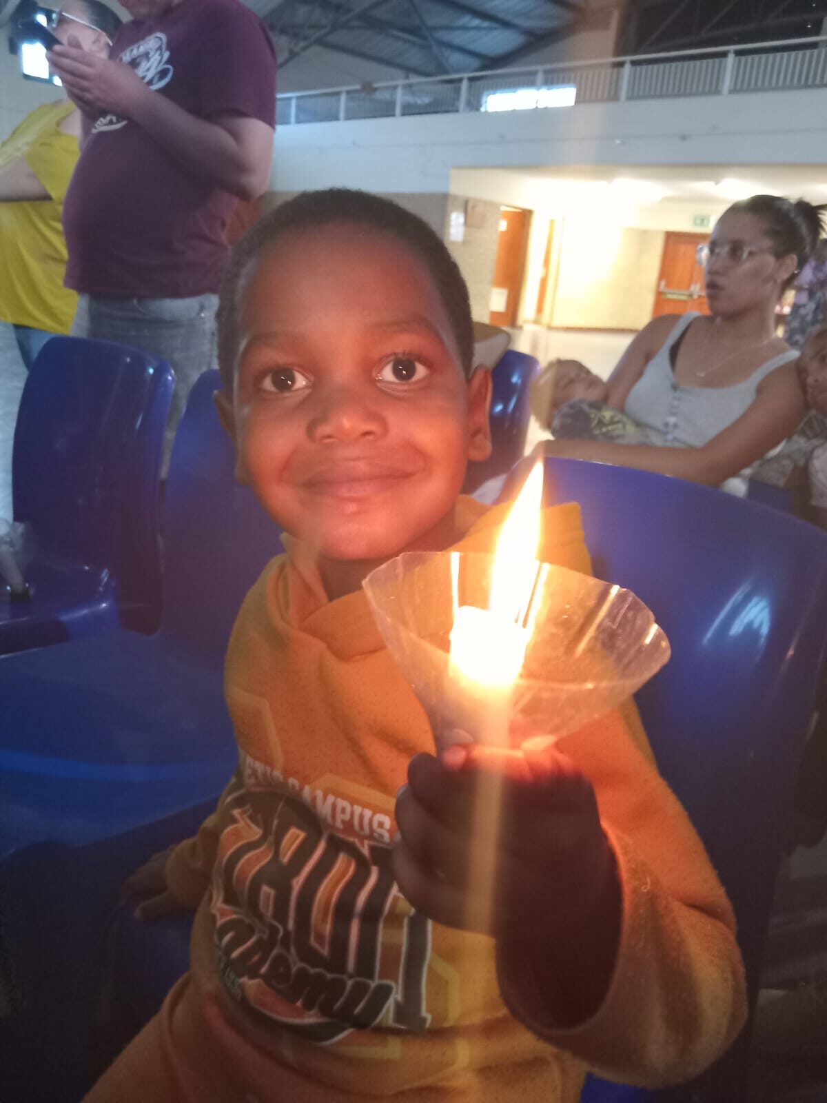 Candlelight carols take on a sombre tone as residents reflect on death toll