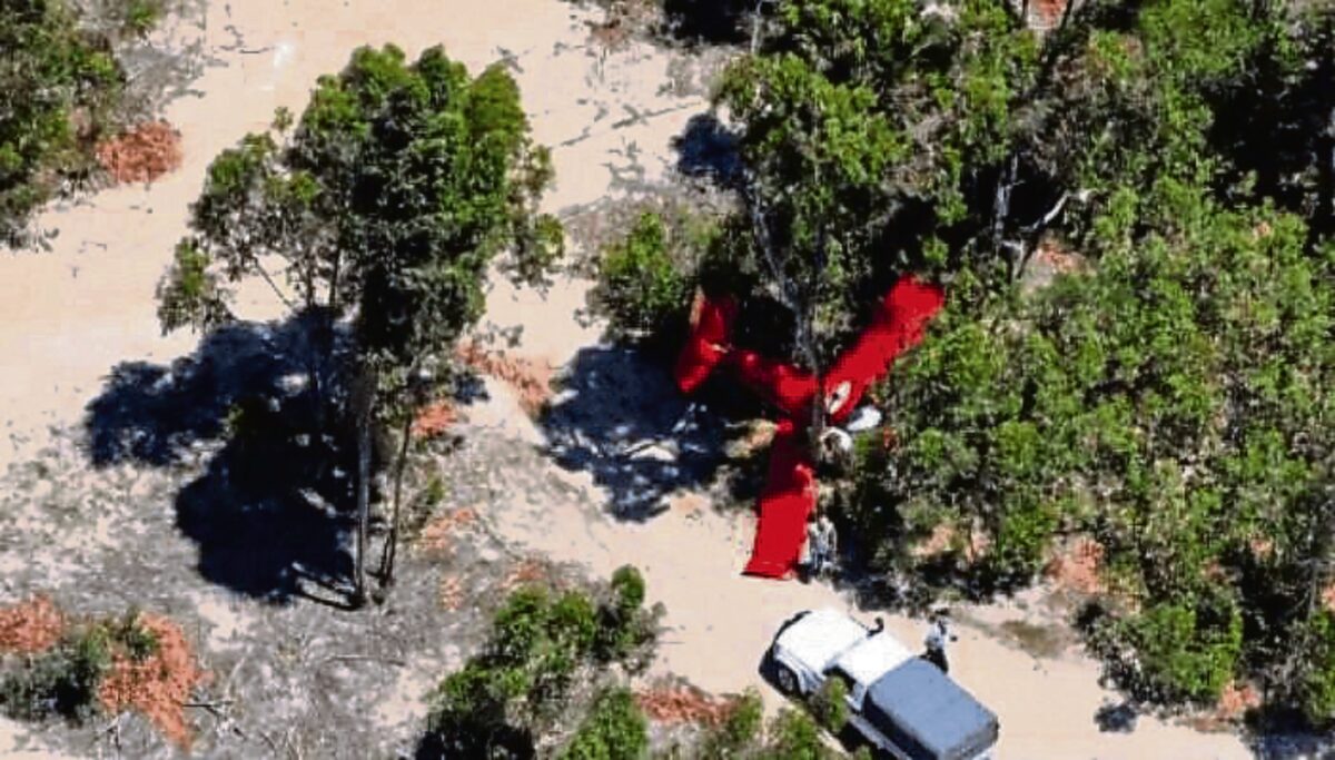 The crash site visible from a distance as police and paramedics take control of the scene.