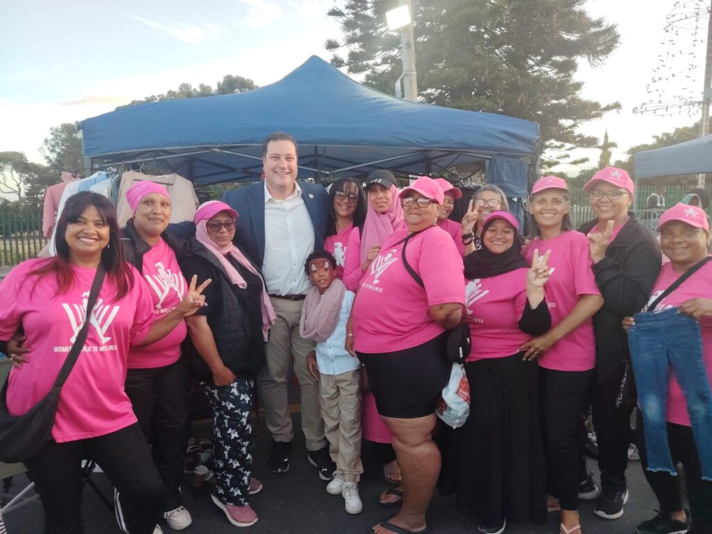 Women's Walk to Wellness pose with Cape Town mayor Geordin Hill-Lewis as the sun sets.