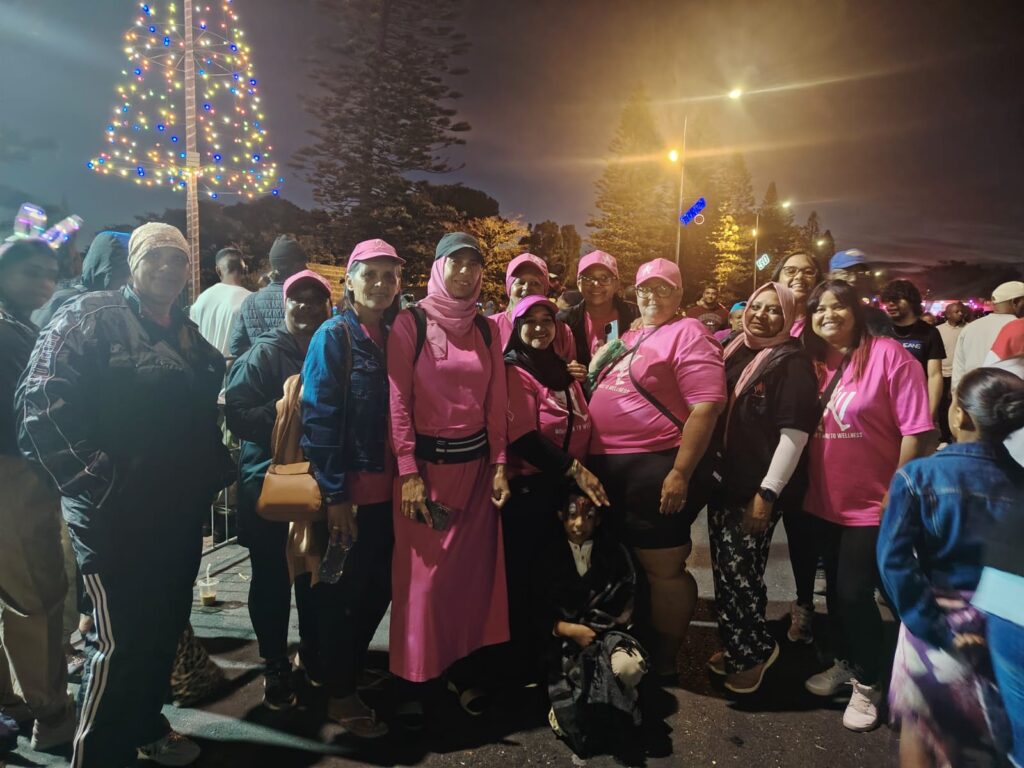 Women's Walk to Wellness pose near the newly switched on festive lights in Morgenster Road.