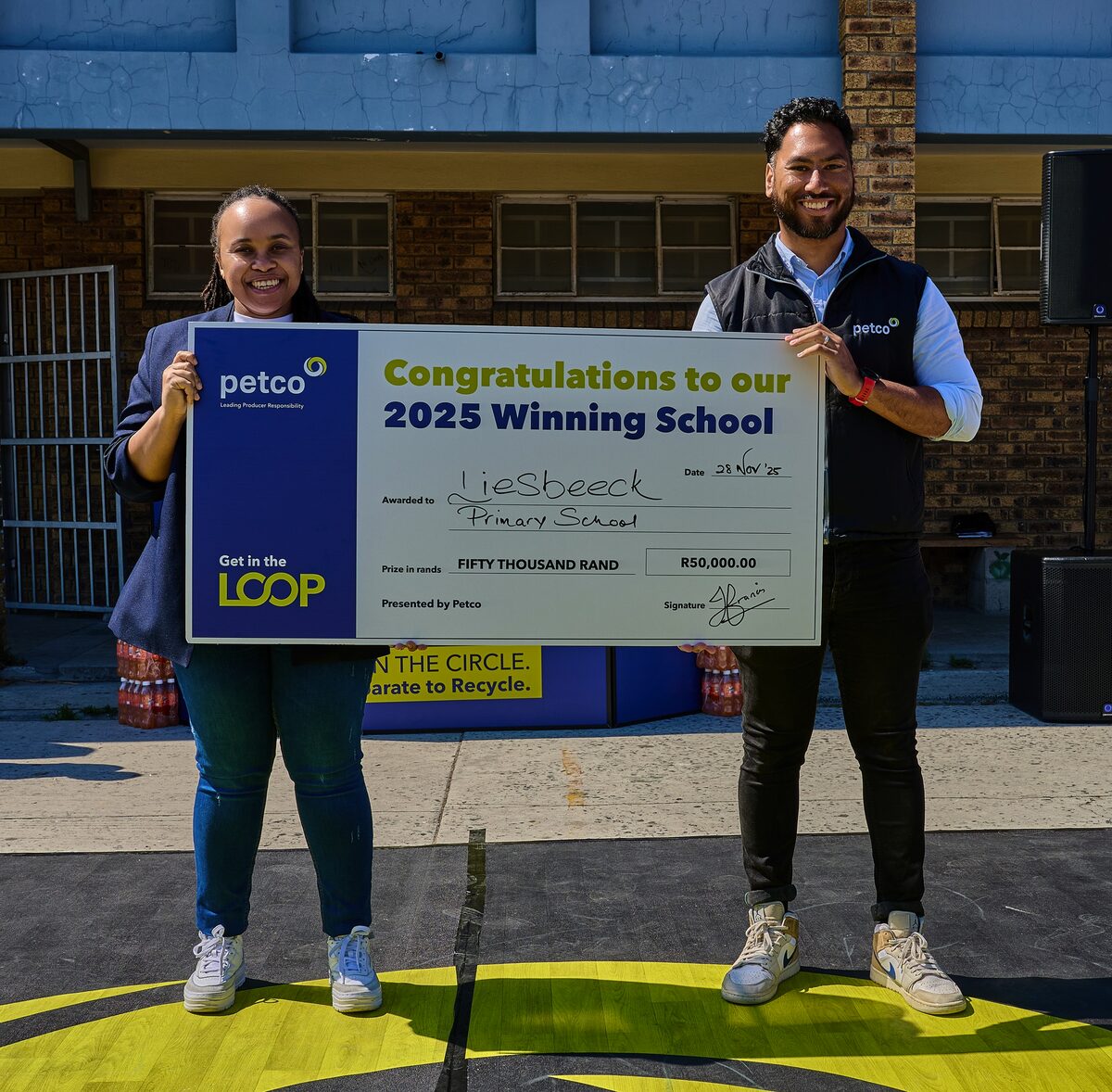 Petco's Samu Mkhize and Junaid Francis with Liesbeeck's winning cheque.