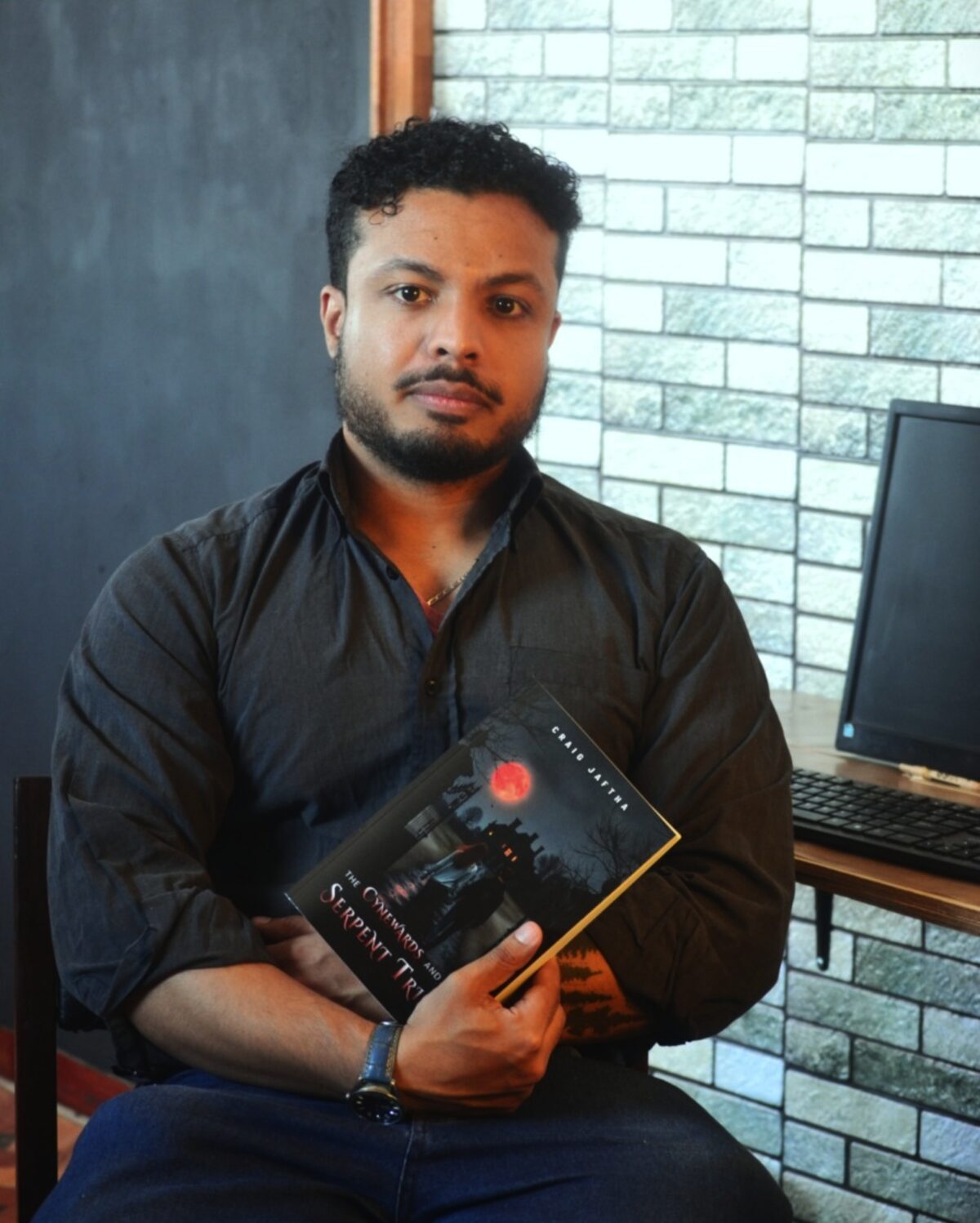 Craig Jaftha with his book The Cynewards and the Serpent Trials.