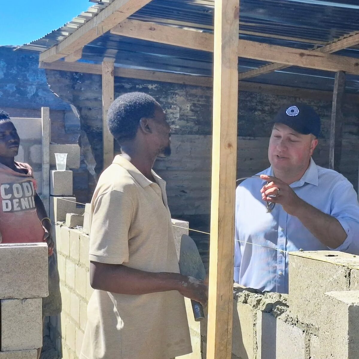 Cape Town Mayor Geordin Hill-Lewis at Site 5 in Dunoon, helping distribute essential aid to displaced families.