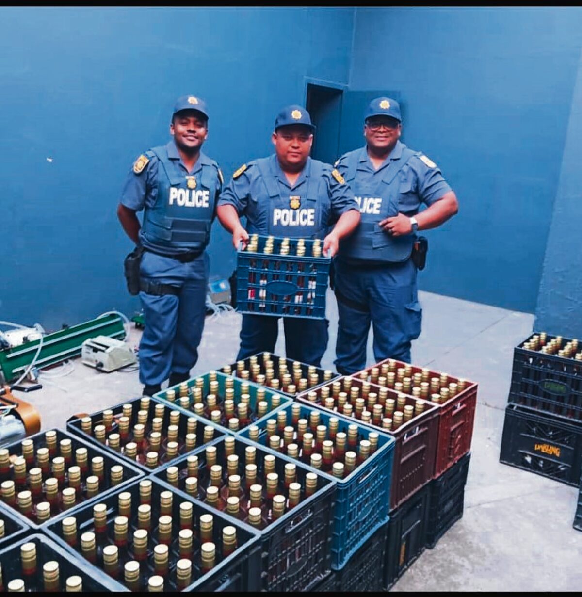 Police officers of Durbanville confiscated the illegally manufactured alcohol. They are (from left) Const Adrian Hannies, Sgt Fabian Heyns and Sgt Dalton Jacobs.