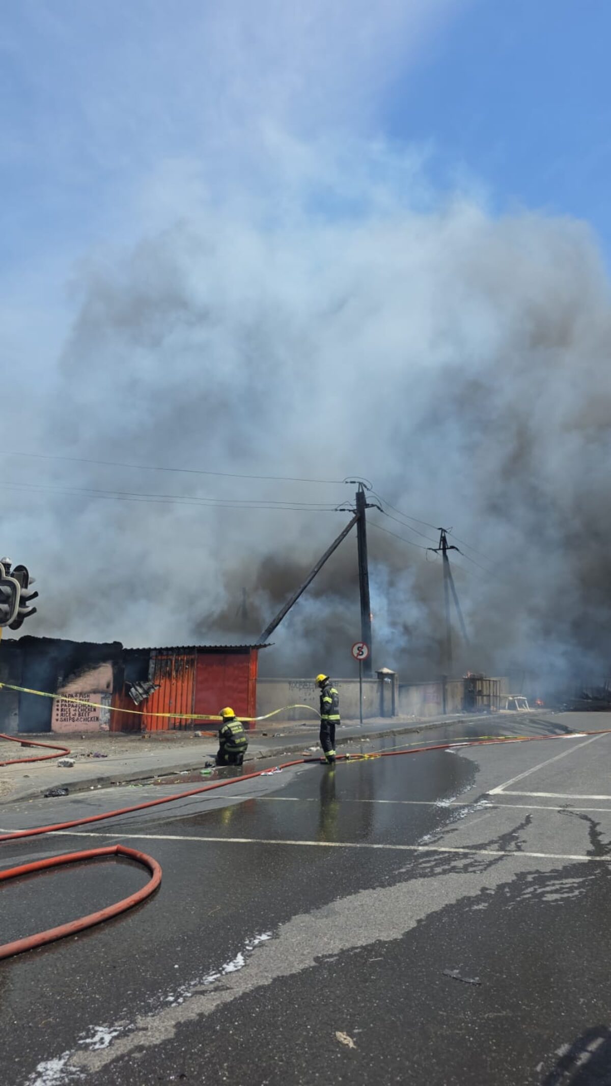 Thick smoke rises over Dunoon as emergency crews respond to multiple structures alight.