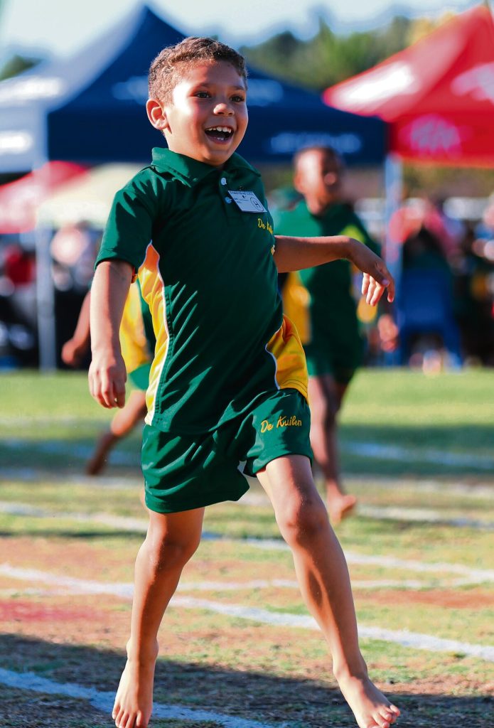 Zade Douman (boys u-7) crosses the finish line.