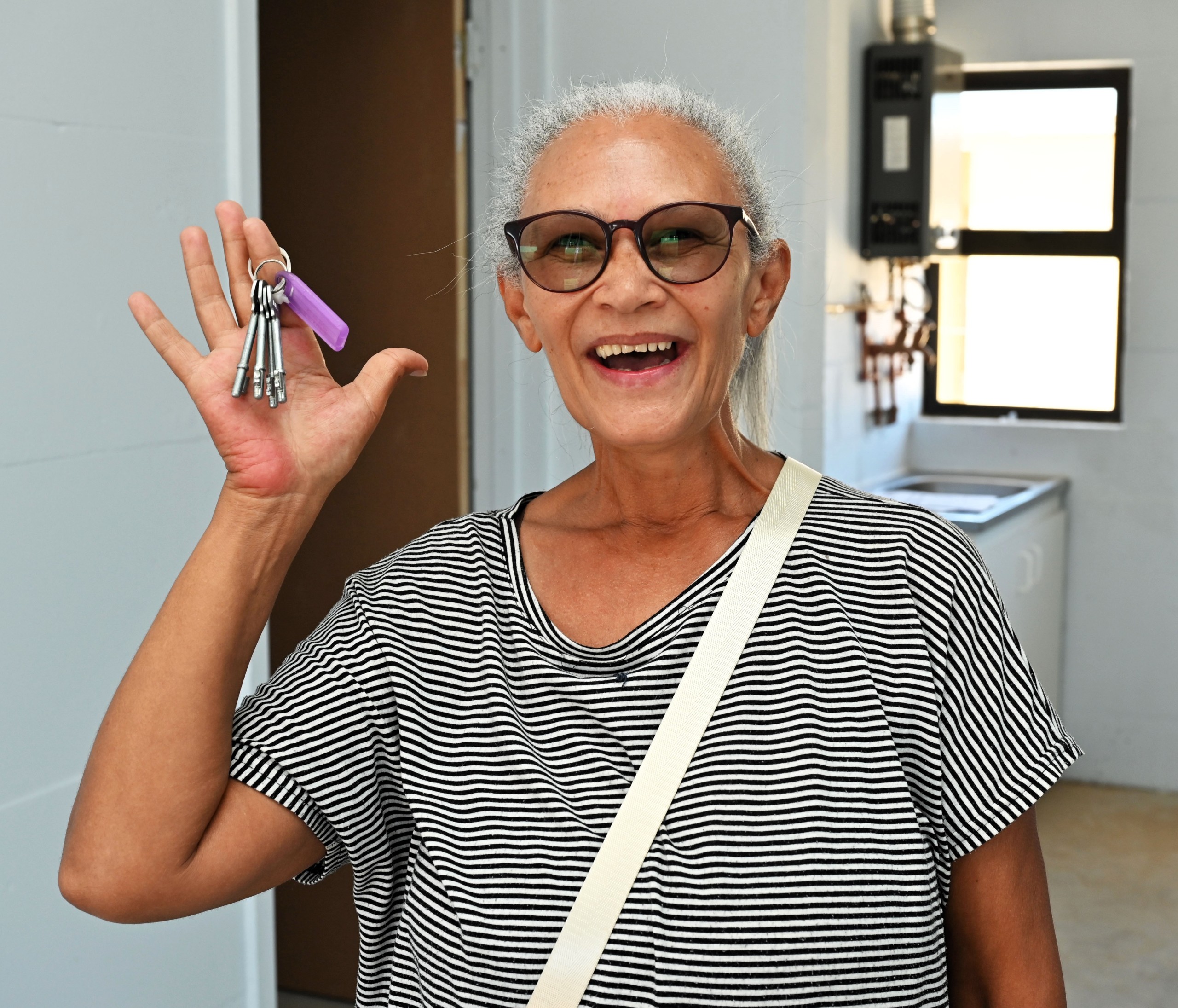 An overjoyed Maria Elizabeth Claasen showing off the keys to her new home in Greenville.