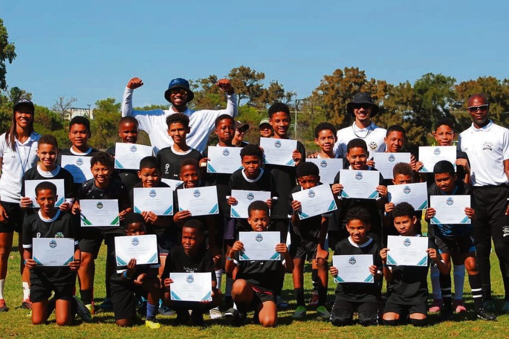 The u-12 attenteed with their certificates received at the conclusion of the event on Sunday. The coaches with them are from left: Astria Boks (A+ Fitness and Coaching/former national player), Lwazi Mlonyeni  (Nkala FTBL), Kyle Maart (Structured Football), and Siya Mbune (Glued Hands Goalkeeping).