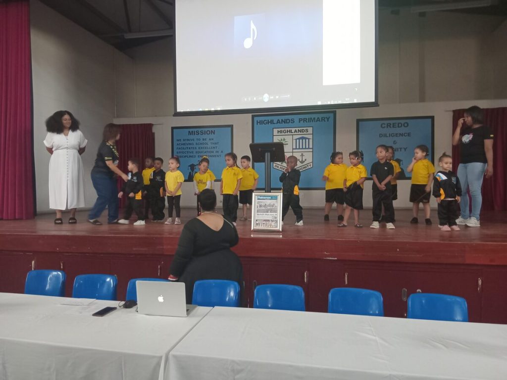 Beacon Valley songstress Marsha Bothma sings the National Anthem with children from Mizpah Educare.