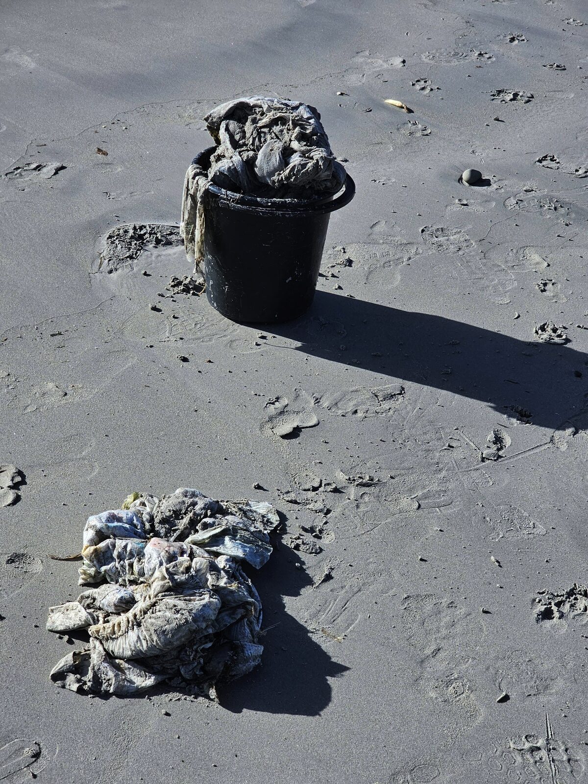 Buckets filled with nappies gathered from the shoreline.