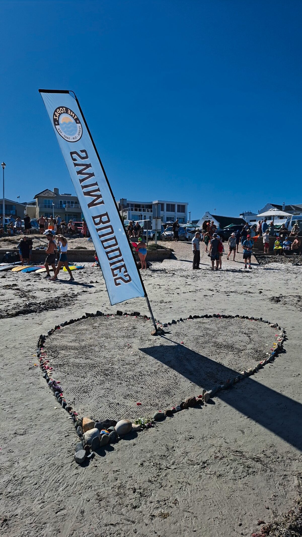 A heart drawn in the sand at Small Bay symbolises the love the community holds for Flanigan.