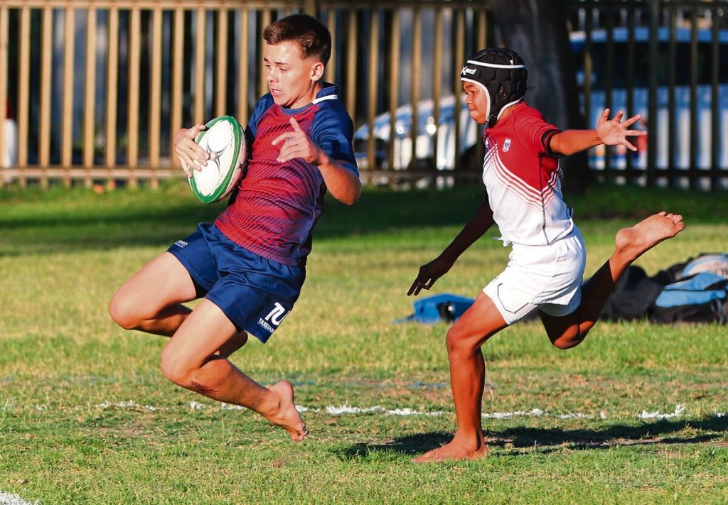 U-13A: Jordan Moss from Curro Durbanville goes over to score a try with Luke Mentor of Vredekloof Primary on his heels.  