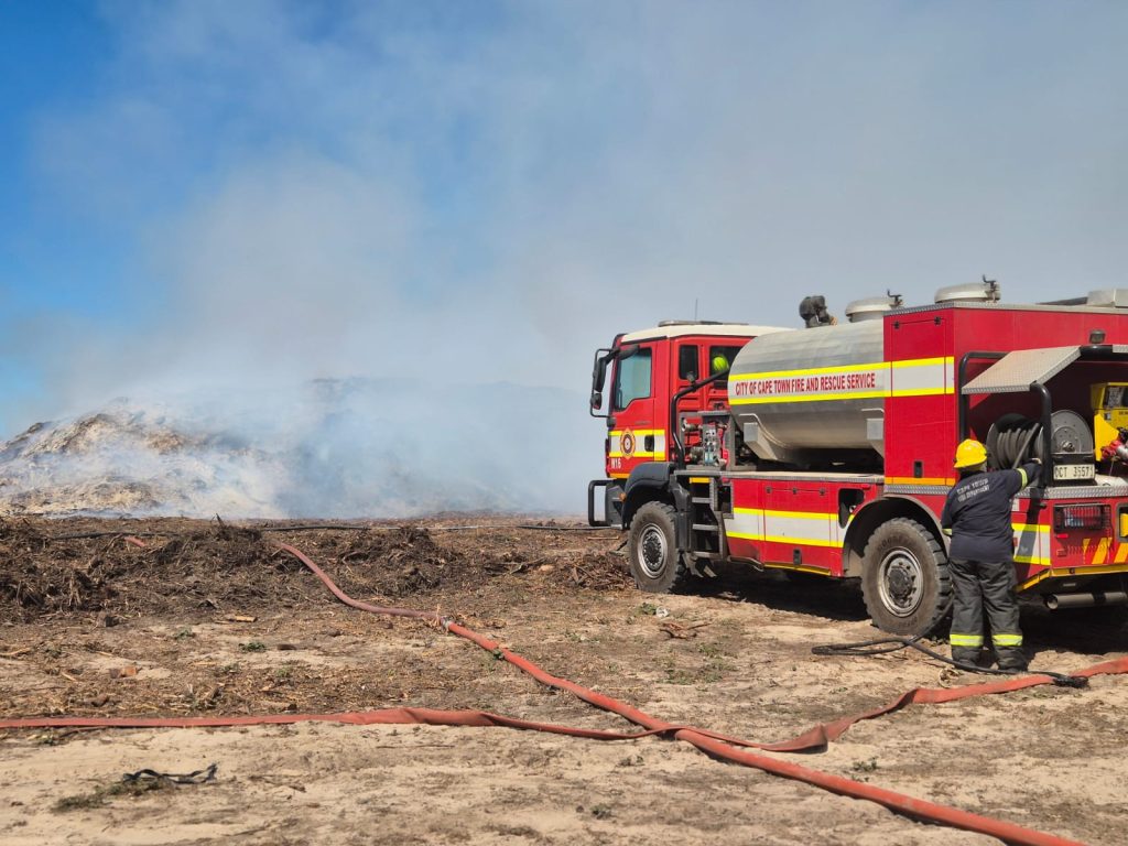 A firetruck douses the flames