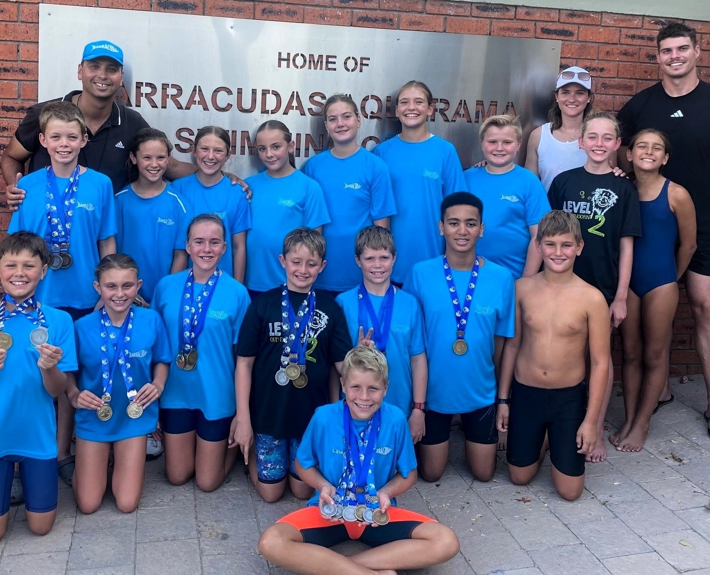 The swimmers with their coaches (back from left) Coenie van Graan (head coach), Lusca Koch and Juan Hayman.