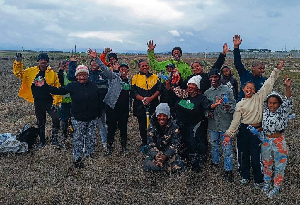 These MRCT volunteers worked before the actual planting event, preparing holes in the rain and also stayed after volunteers left to finish planting trees and plants. Photo: Danielle Cronje