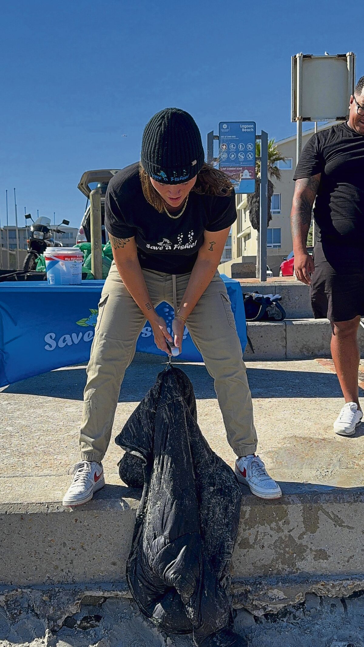 oë Prinsloo, founder of Save a Fishie, weighs the 528kg of litter collected during the Easter clean-up.