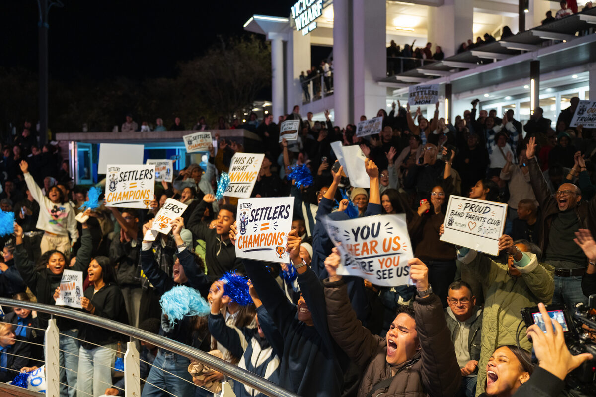 The Proud Band Parents Club was among those who turned out in numbers, armed with blue pom-poms and signs proclaiming "Settlers = Champions."