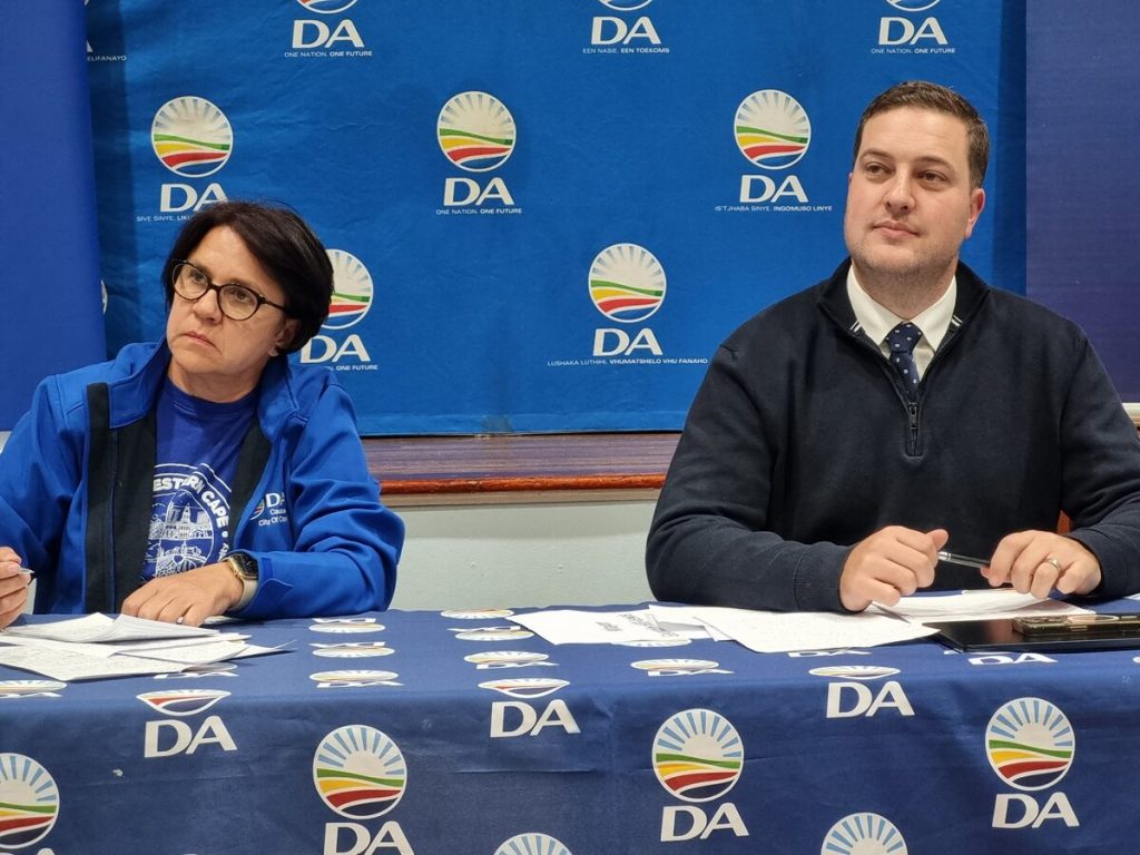 Geordin Hill-Lewis listens to questions from the floor. On the left is Ronel Viljoen, chair of Tygerberg 3 Constituency.