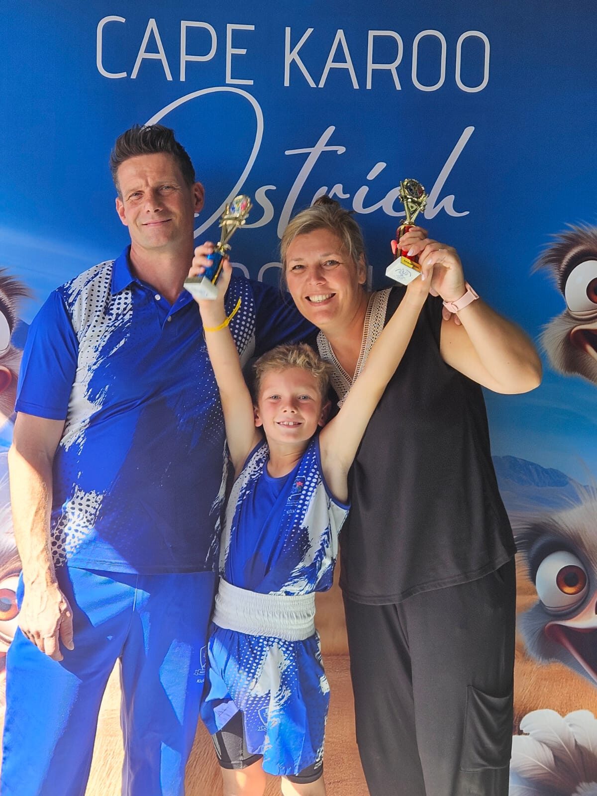 
Levi Grove celebrates his South African kickboxing title with proud parents Wayne and Sharleen Grove.