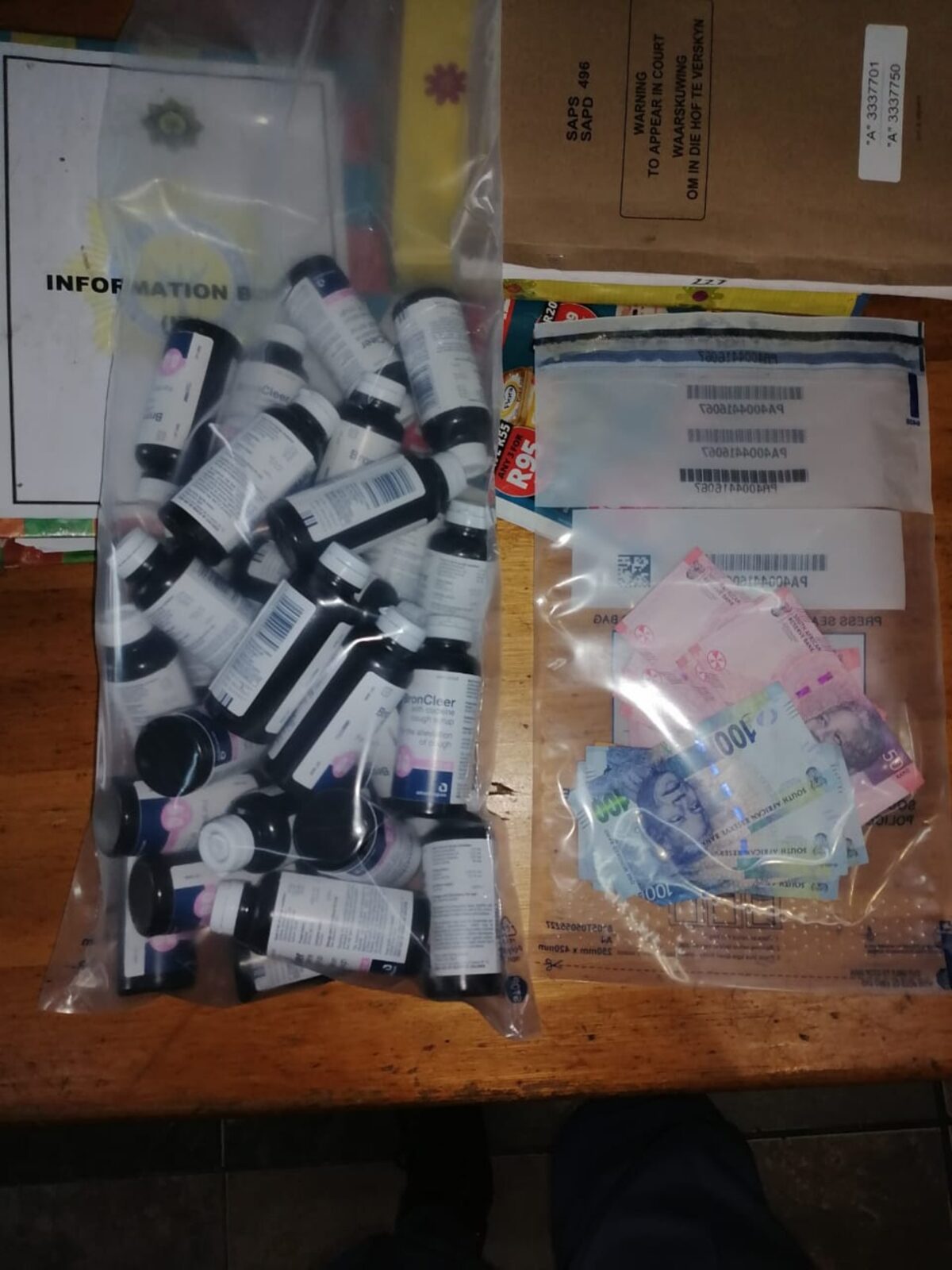The 27 bottles of cough mixture and an undisclosed amount of cash seized by members of Public Order Policing in Bellville on Friday, 1 May 2026.