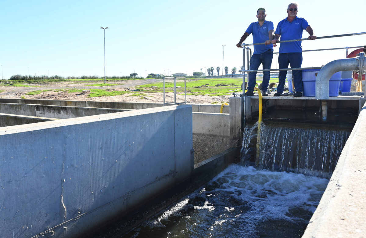 Clint Kleinhans (seniorsSuperintendent at Scottsdene WWTW) and Jacques Basson (WWTW plant manager) at the final discharge point where treated effluent leaves the plant for reuse.