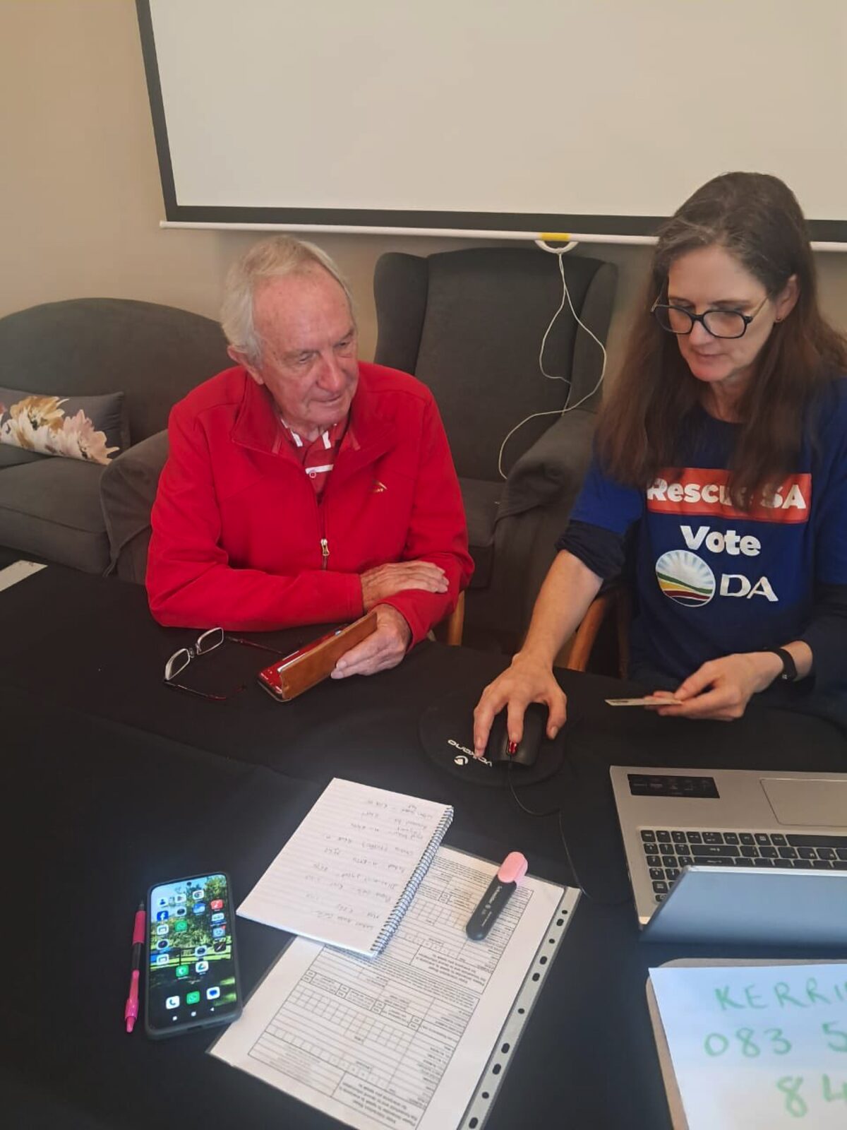 Community members receive assistance with voter registration.