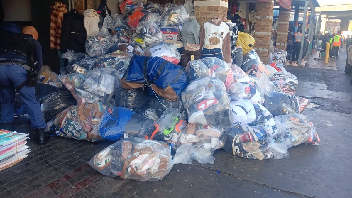 Bags of counterfeit sneakers, shoes, and branded clothing seized during the joint police and Brand Protectors operation in Bellville, valued at an estimated R98 000 000. Photo: SAPS