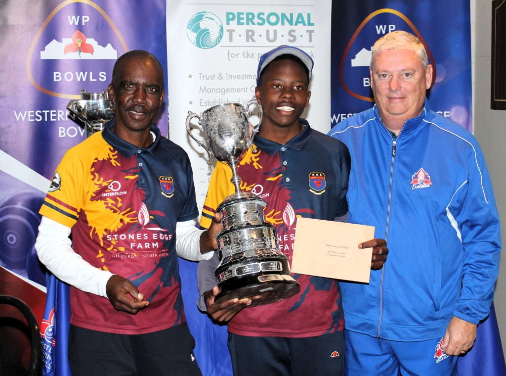 Alfred and Thando Mraji receive their much coveted WP Pairs trophy from WP Bowls president Tony Harland.