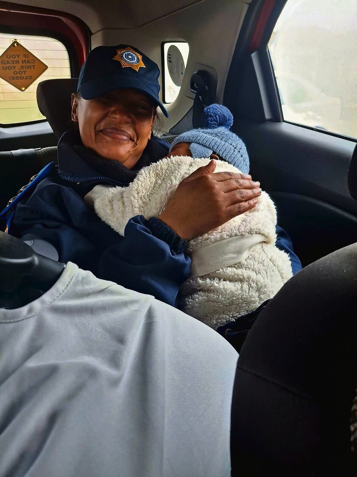 Senior Inspector Deirdré Thomas consoling the baby.