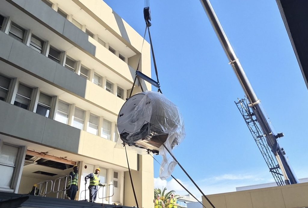 The MRI machine being hoisted into its new position.