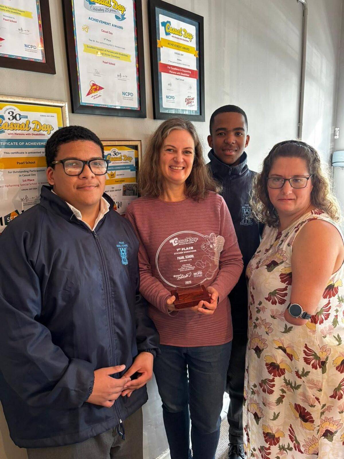 Proud to receive the trophy are Luke Adams (learner), Elizbè van der Colff, Geraldo Griffins (learner), andAdri Visser (Casual Day).