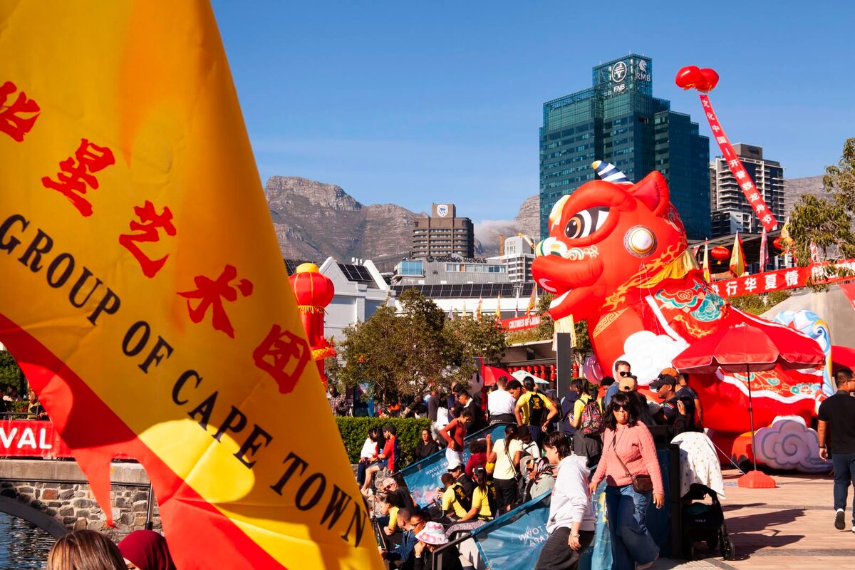 Red lanterns, a towering inflatable dragon, and the flag of the Cape Town Chinese arts group set a festive scene at Battery Park during the 4th "Cultures of China – Cape Town Dragon Boat Festival".