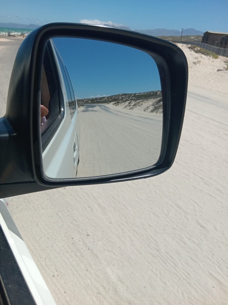 Long stretches of the road are completely covered by sand.