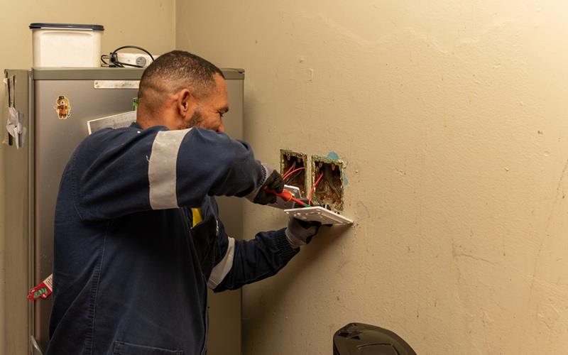 A City of Cape Town employee fixes electrical faults in Uitsig.