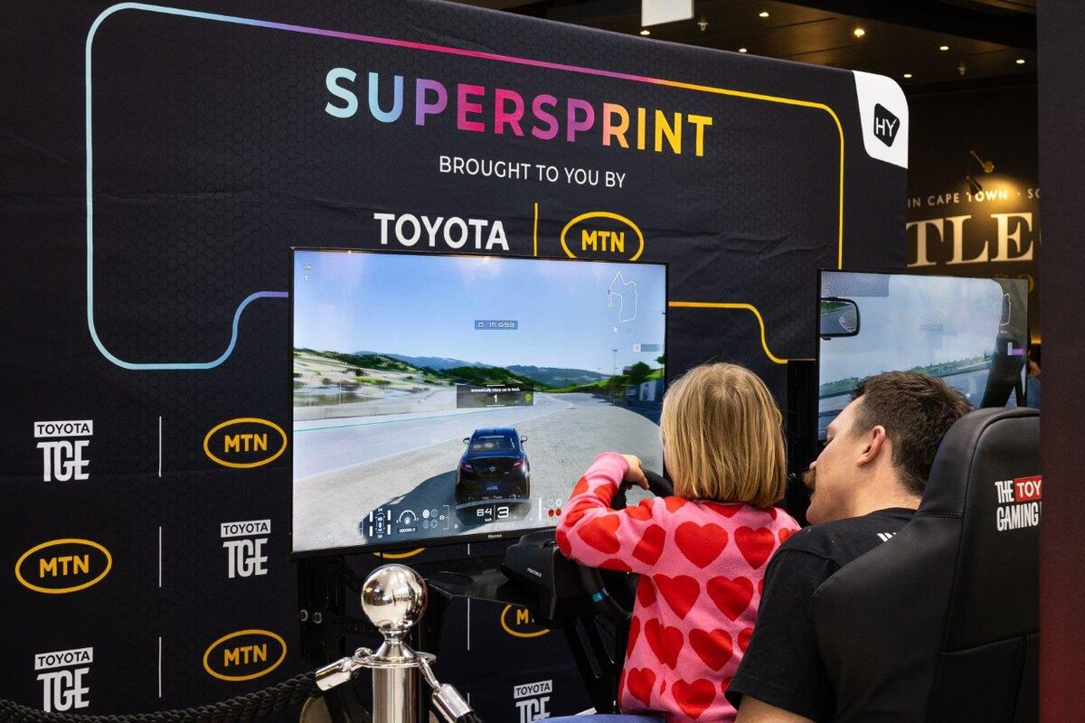 A father and child enjoy gaming together at the MTN SHIFT experience.