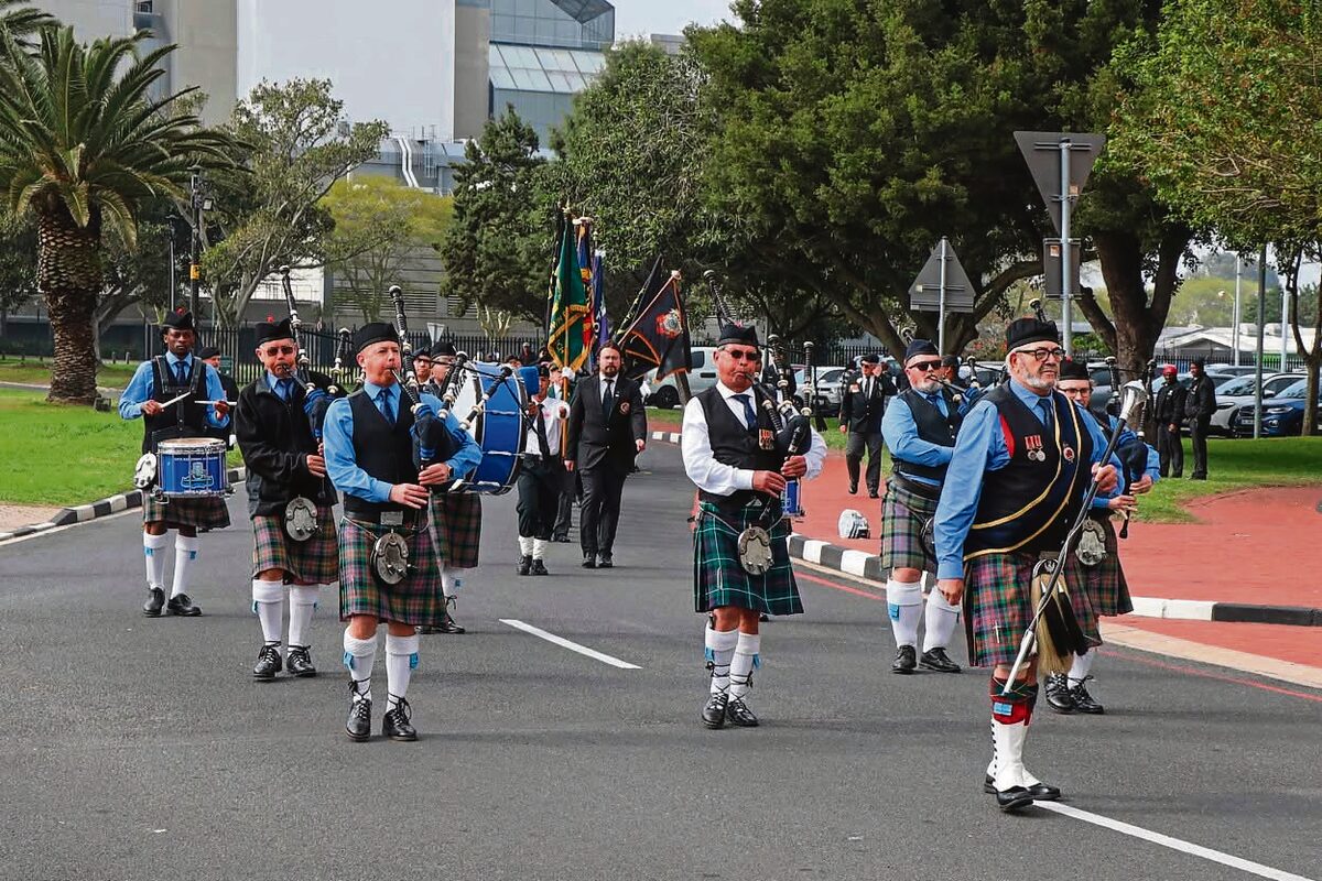 The band and banners march to the Bellville Civic Centre.