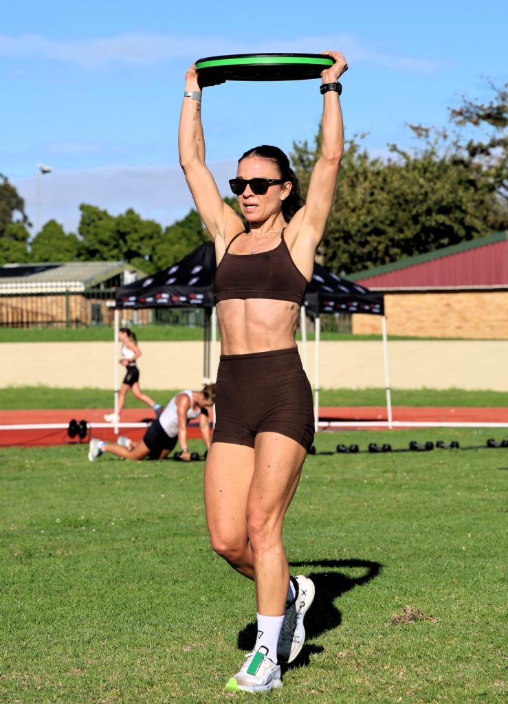 Courtney Wallander is carrying a 10kg weight overhead.