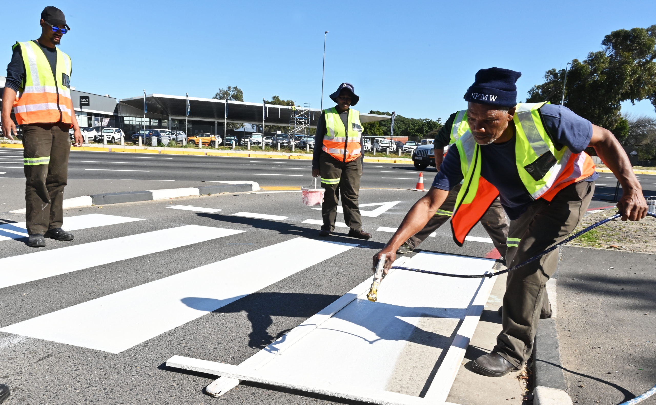 Fresh road markings being painted at the busy intersection outside the Killarney bus terminus.
