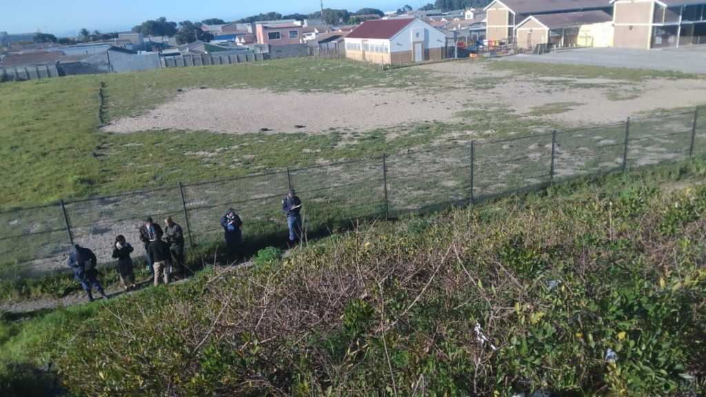 Police investigate the scene where a body was found yesterday.