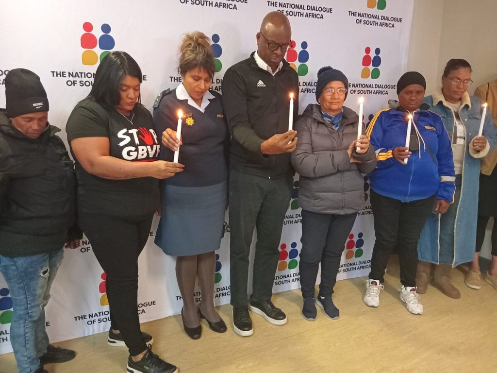 Eight candles are lit during a moment of silence for the victims of the Ekurhuleni killings.